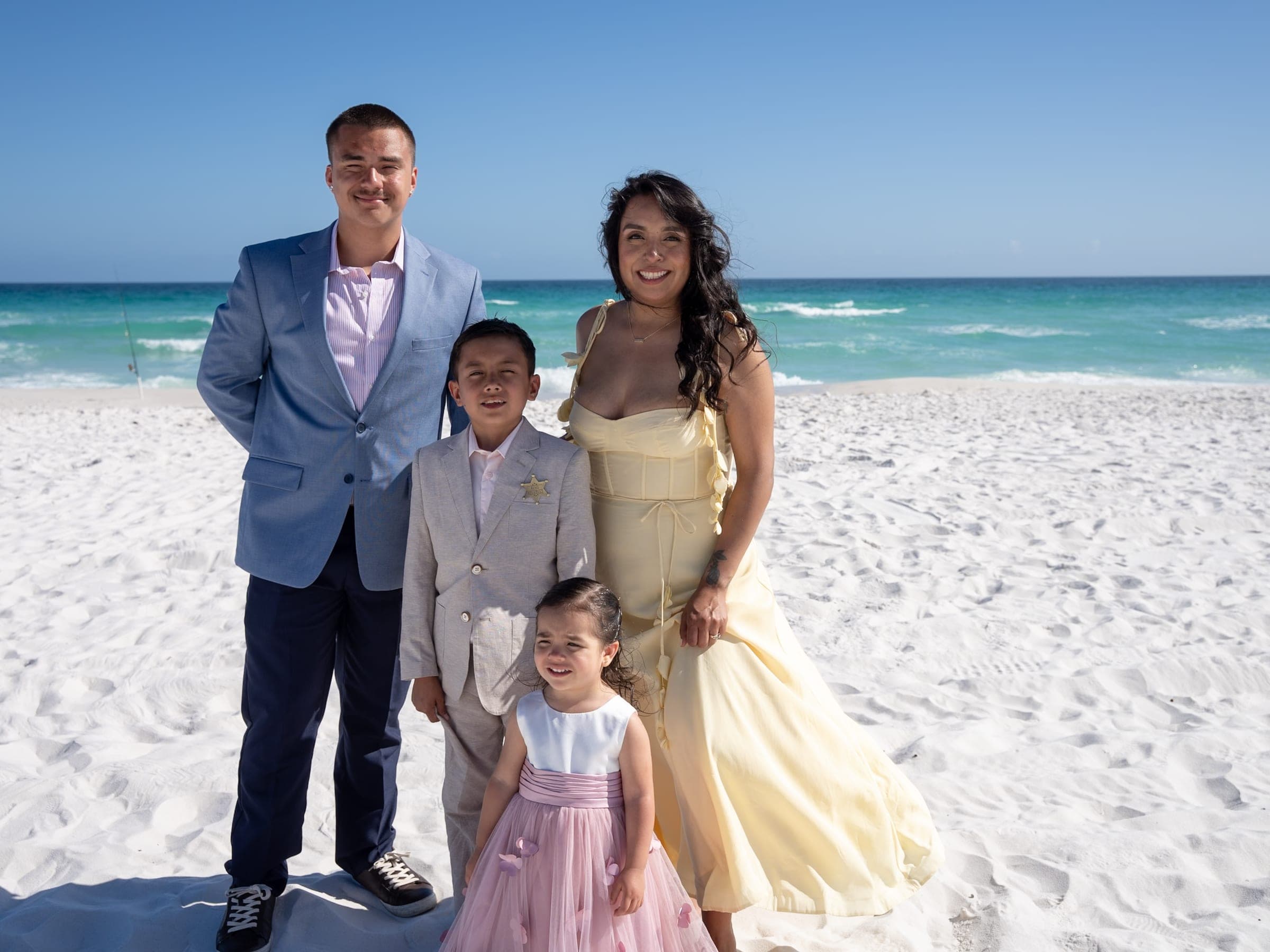 Michael Fisher and his family together on the beach
